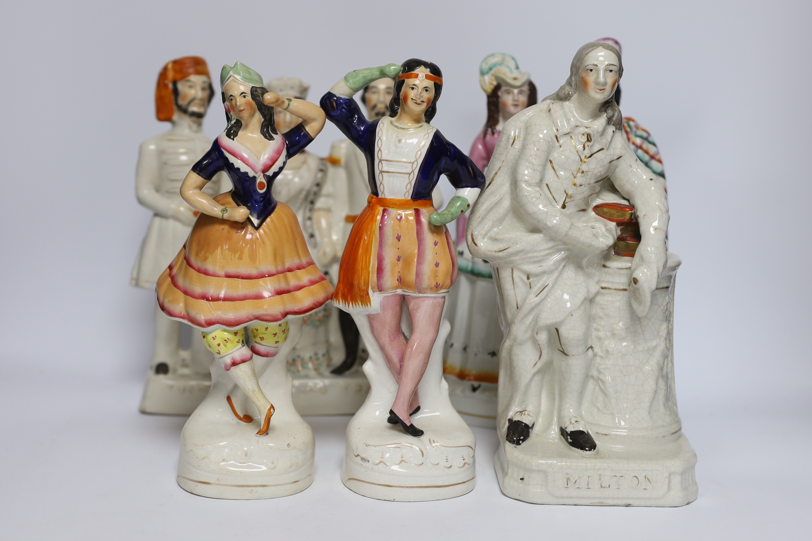 Seven 19th century Staffordshire flat back figure groups, including figures of Milton, Nelson, a pair of dancers, etc., tallest 29cm